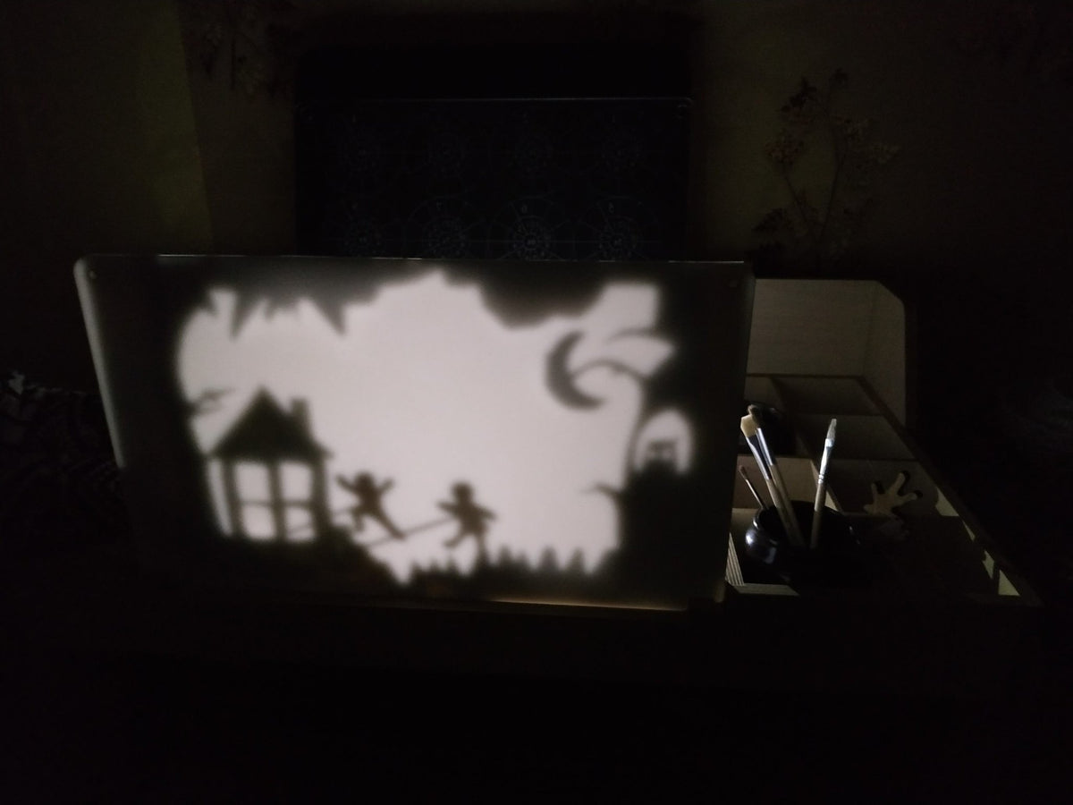 9. LUULA acrylic whiteboard with shadow figures in dark room