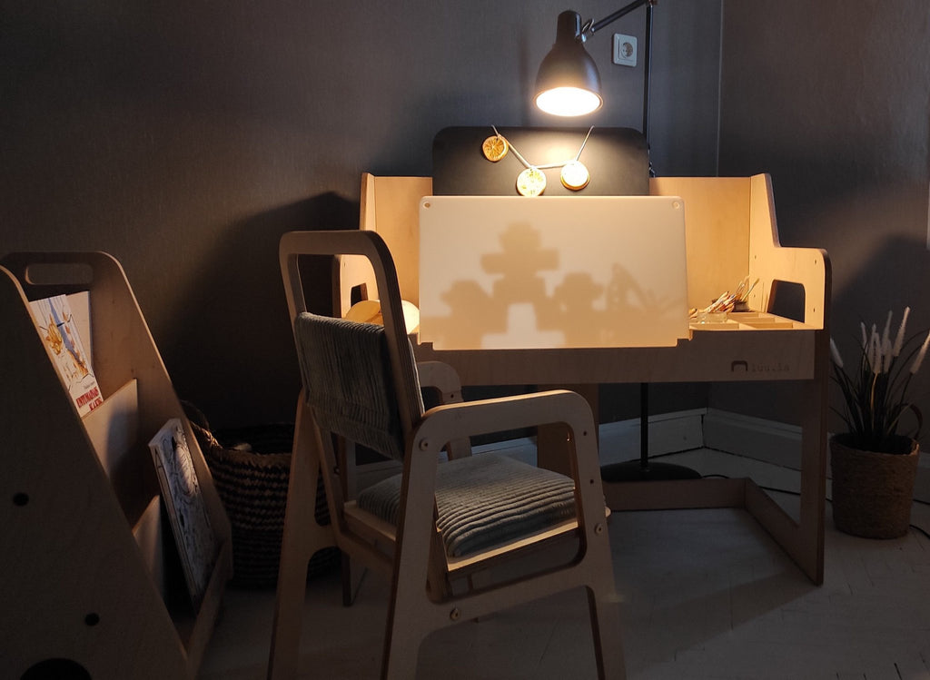7. LUULA acrylic whiteboard on desk with chair and shadow play in dimly lit room