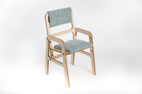 2. Adjustable children's chair in mint green with padded seat and removable backrest, made from Baltic birch plywood, shown in studio setting