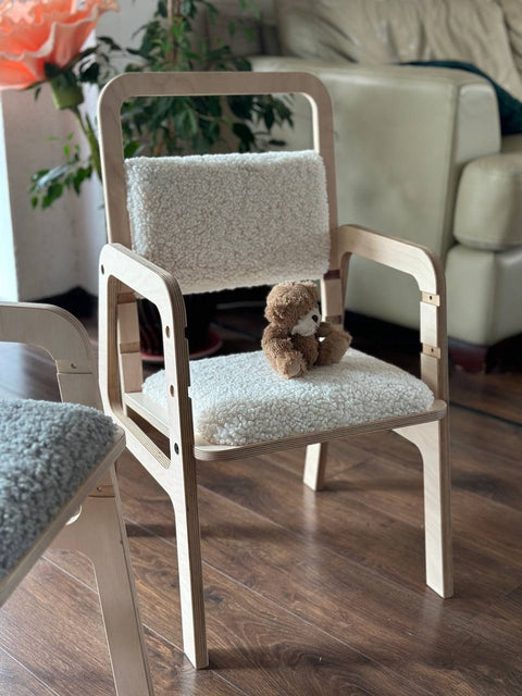 5. Luula adjustable children's chair in natural wood with vanilla lamb padding, featuring a teddy bear on the seat