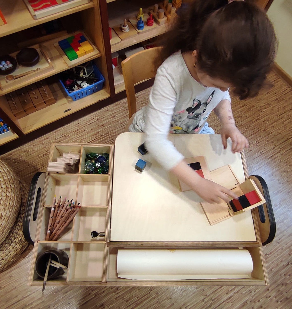 1. Girl using Montessori table with chalkboard in a bright room