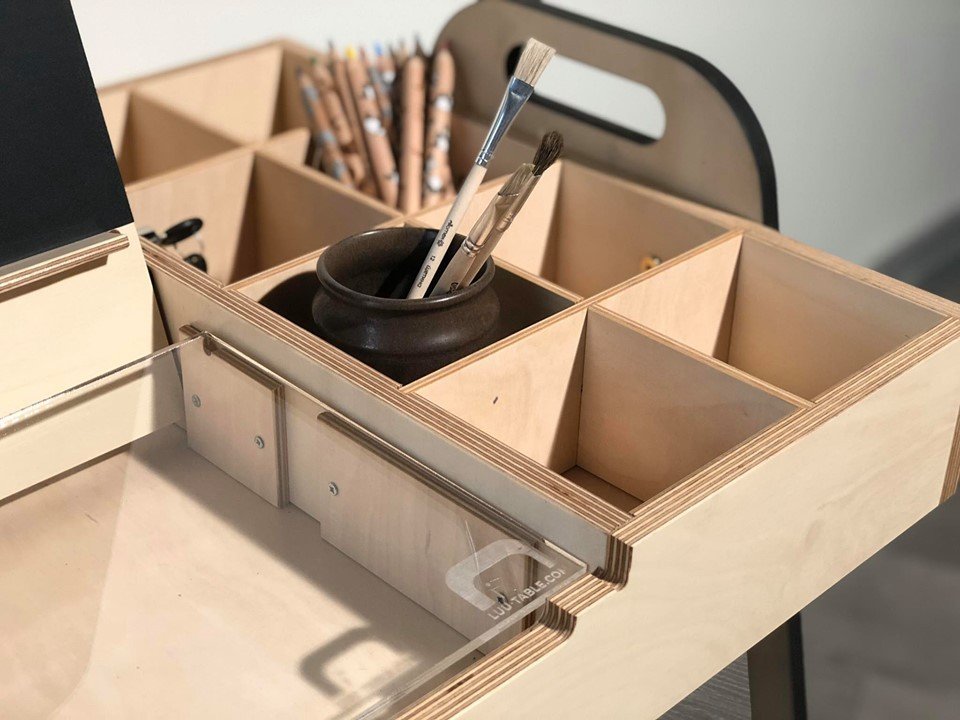 3. Close-up of Montessori table's storage compartments with pencils