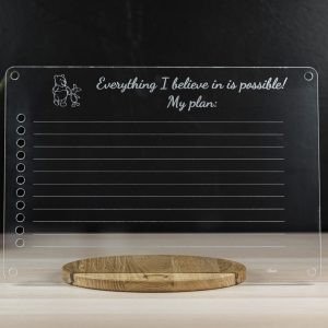 4. Transparent acrylic board with motivational text on a wooden base