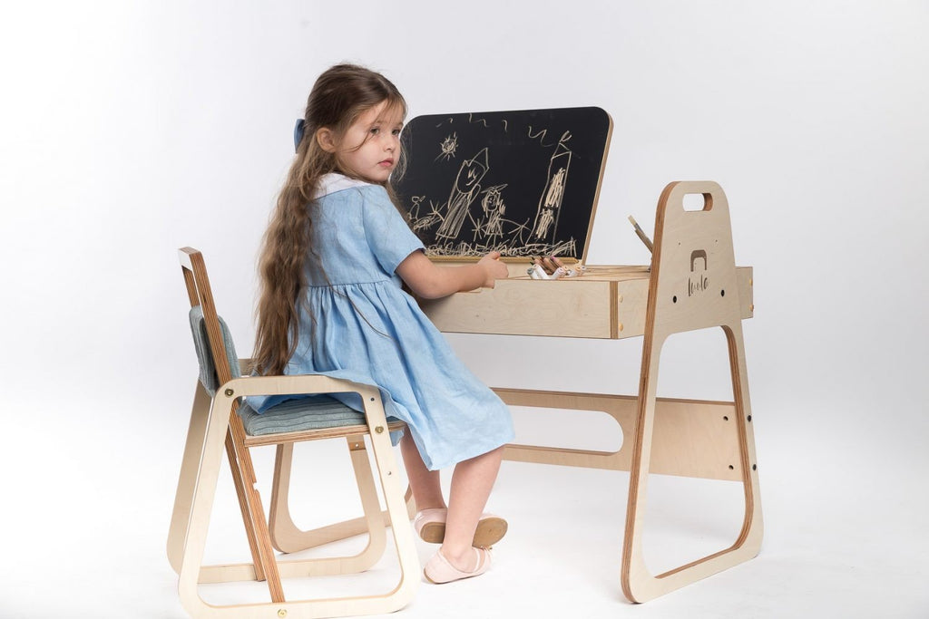 1. Girl using Montessori table with chalkboard in a bright studio