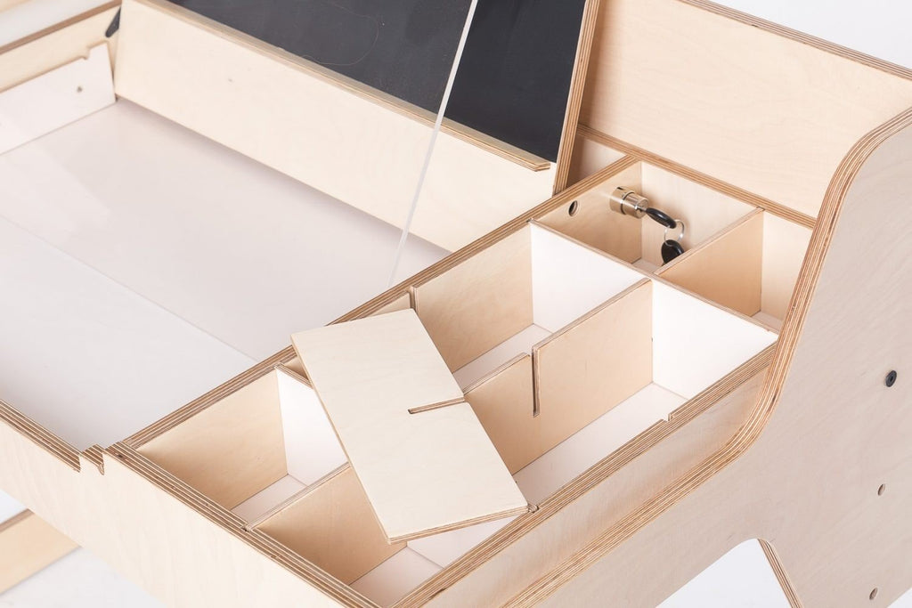 7. Detail of Montessori table storage compartments with removable lids, showcasing organization and functionality.