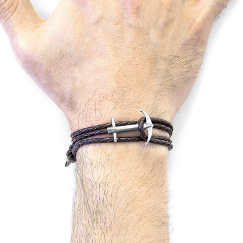 2. Close-up of men's Admiral Anchor silver and dark brown braided leather bracelet by ANCHOR & CREW, worn on wrist
