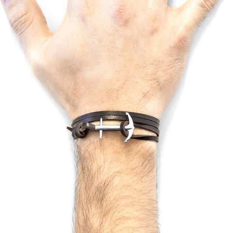 2. Lifestyle image of ANCHOR & CREW dark brown leather bracelet with silver anchor worn on male wrist