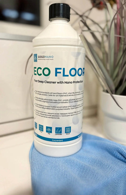 4. GoGoNano EcoFloor natural floor cleaner 1L bottle on a blue cloth near a plant