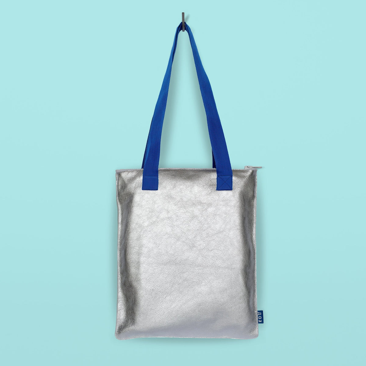 5. Studio shot of Daz Studio handmade silver leather tote with blue nylon straps