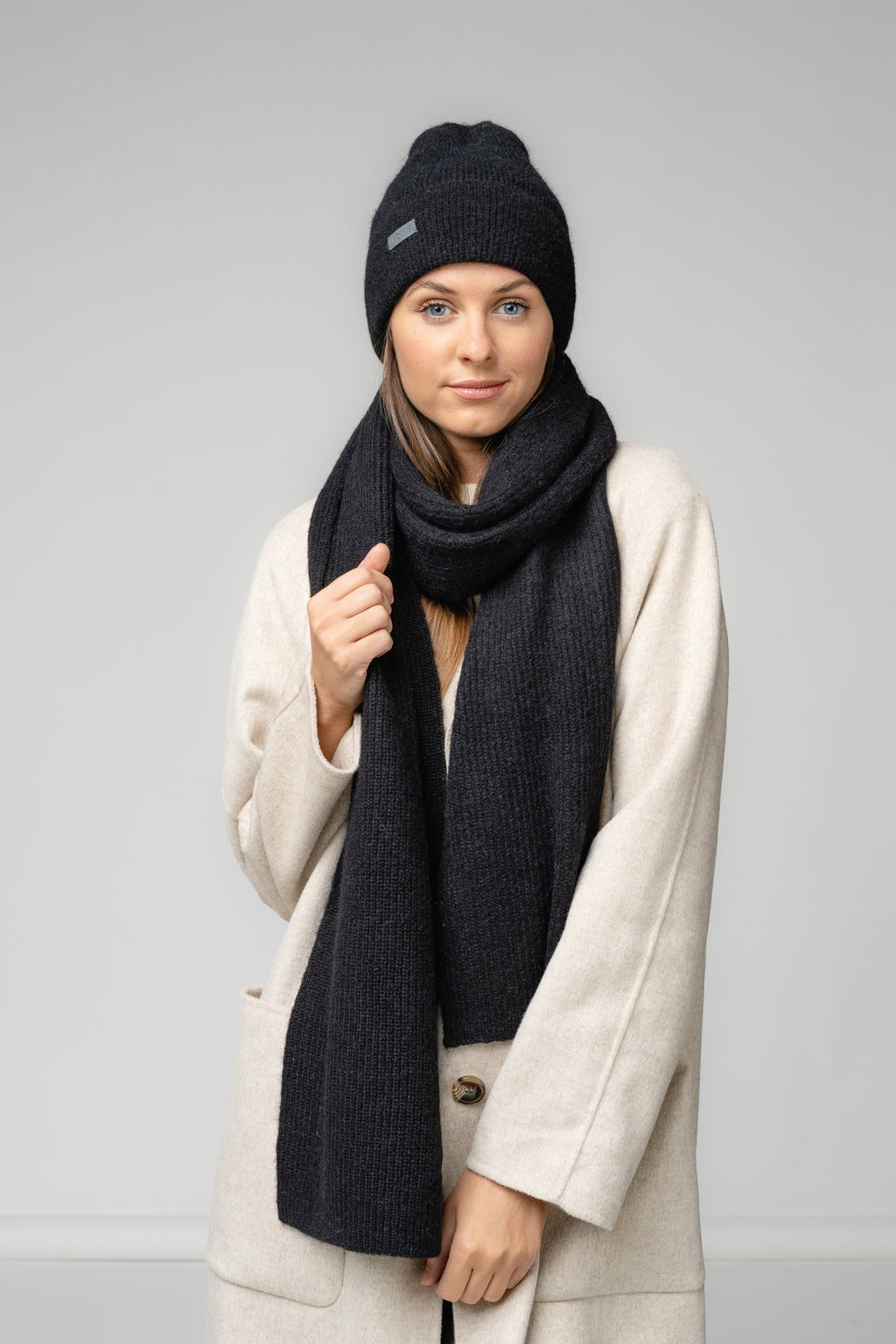 1. Women's black Alpaka Fisherman's Rib scarf and hat set in studio setting