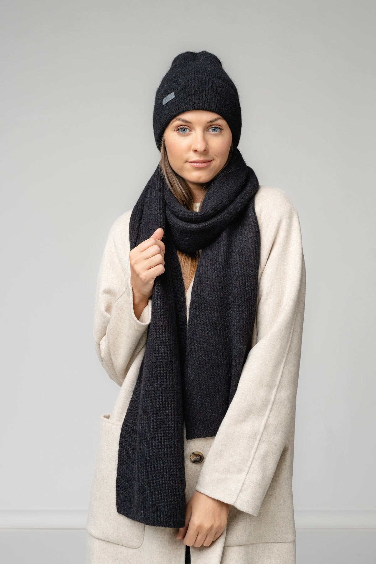 1. Women's black Alpaka Fisherman's Rib scarf and hat set in studio setting