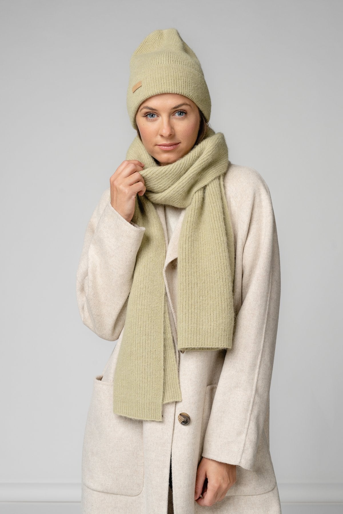 13. Women's musk green Alpaka Fisherman's Rib scarf and hat set in studio setting