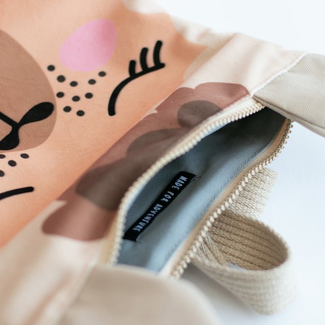 8. Close-up of Muni llama backpack zipper and interior, showing grey lining and sturdy design