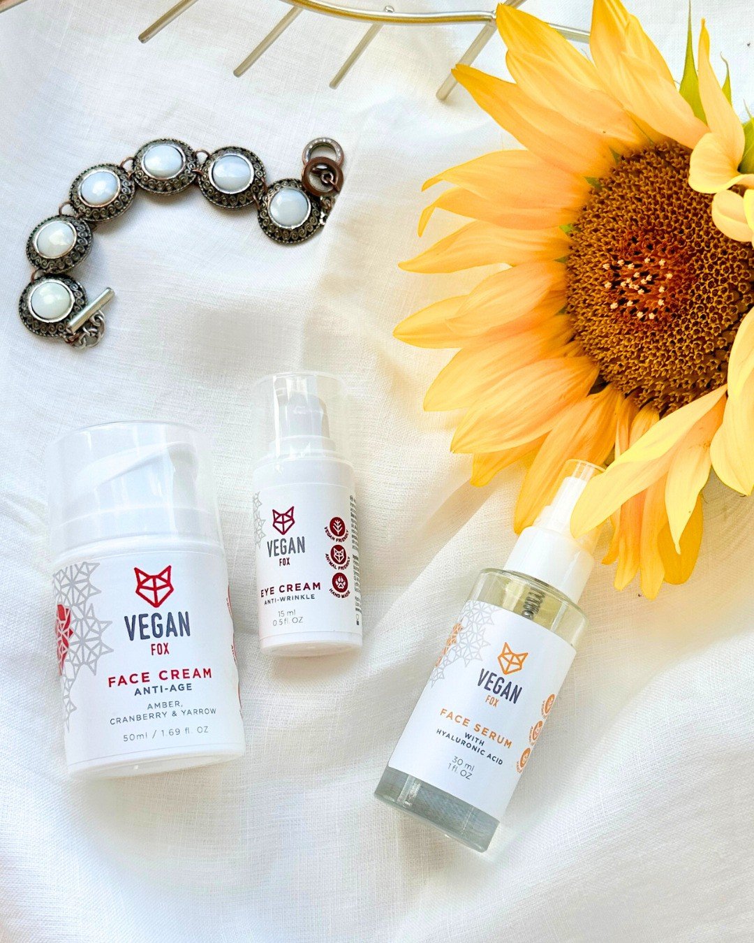 2. Vegan Fox Anti-Age Face Care Set including face cream, eye cream, and serum with sunflower and jewelry in a lifestyle arrangement
