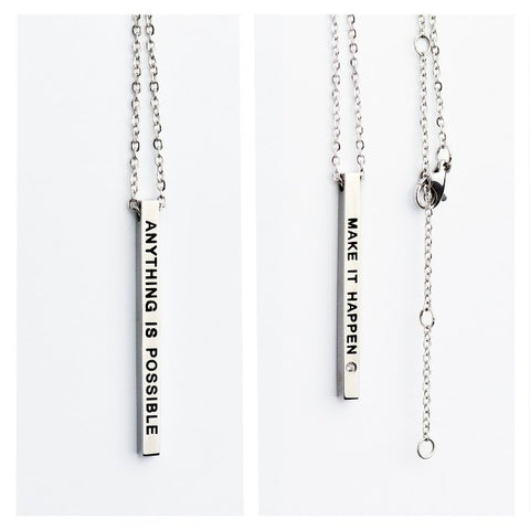 2. Studio image of Olla necklace with double-sided pendant featuring 'Make it Happen' and 'Anything is Possible' inscriptions in silver