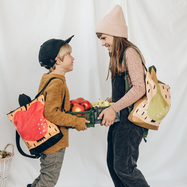 2. Children with Muni apple and pear backpacks, highlighting vibrant colors and style
