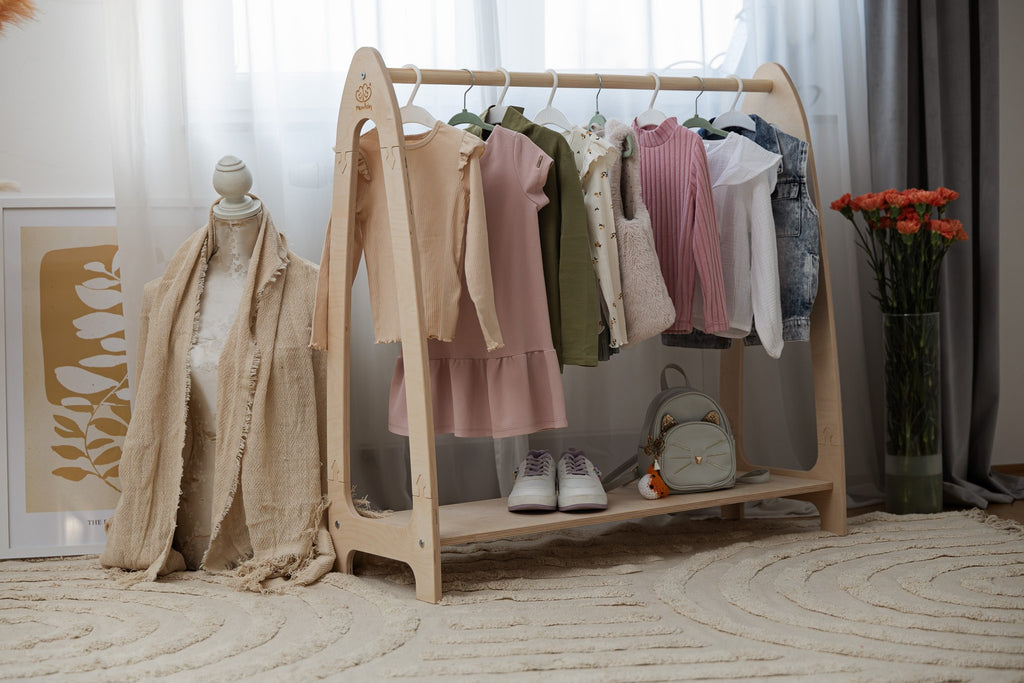 1. Natural wood clothing rack for children with clothes, shoes, and decor in bright room