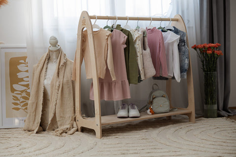 1. Natural wood clothing rack for children with clothes, shoes, and decor in bright room