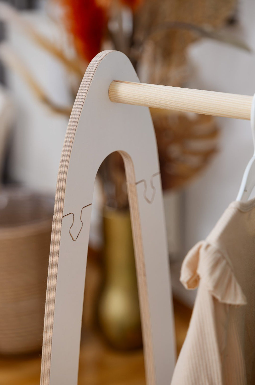 3. Close-up of the top section of MeowBaby arched clothing rack, showing wooden bar and side detail