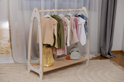 1. MeowBaby arched clothing rack for children with clothes and a bag, set in a contemporary room