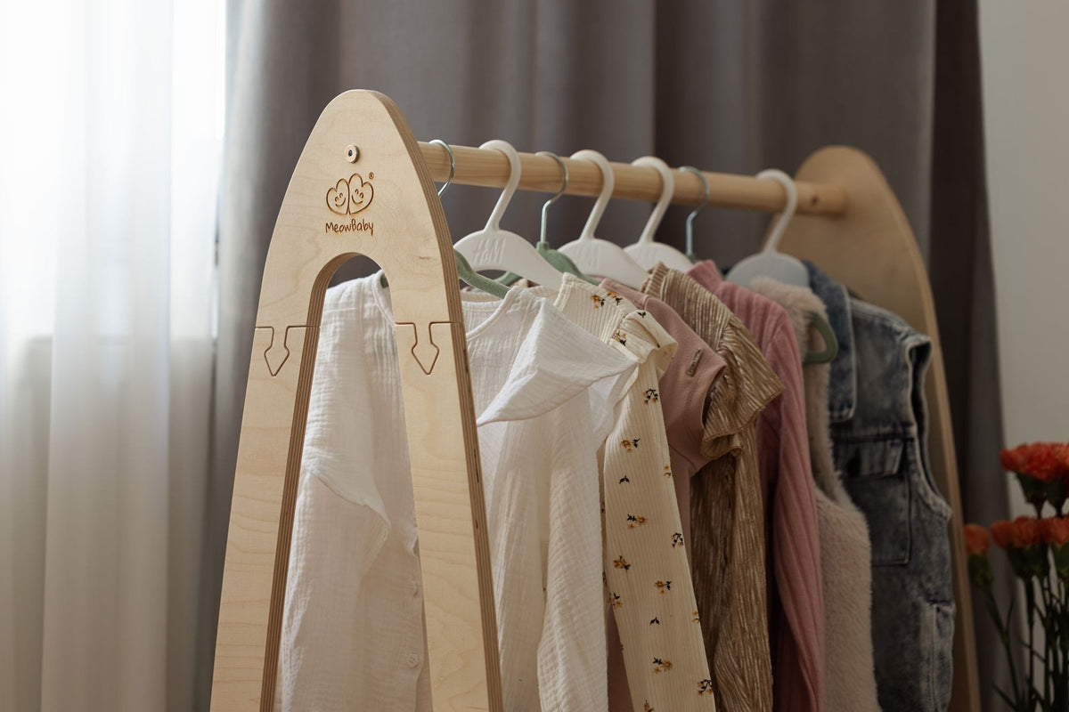 4. MeowBaby arched clothing rack with children's clothes hanging, close-up view