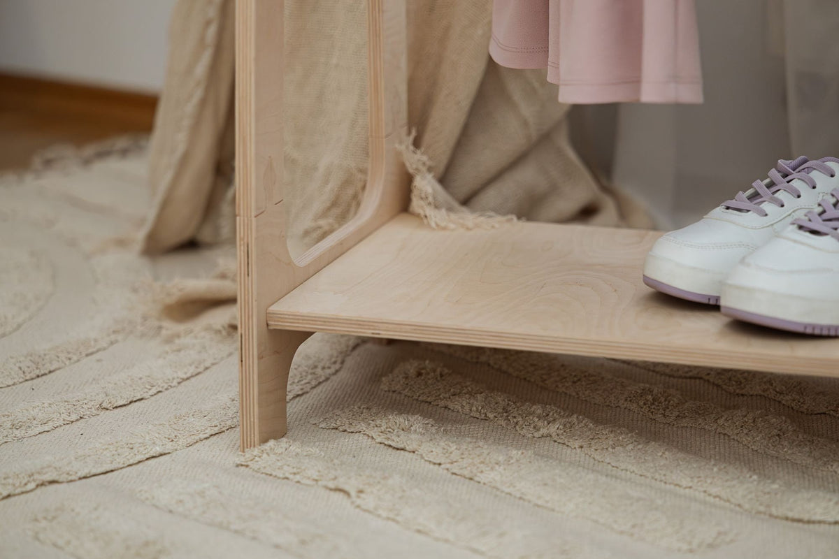 3. Close-up of MeowBaby arched clothing rack shelf with sneakers and pink dress