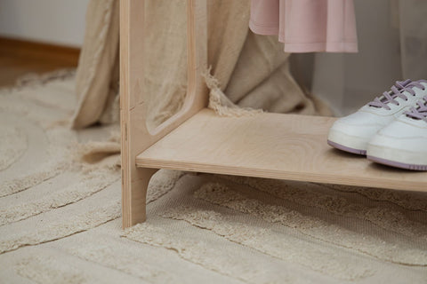 3. Close-up of MeowBaby arched clothing rack shelf with sneakers and pink dress