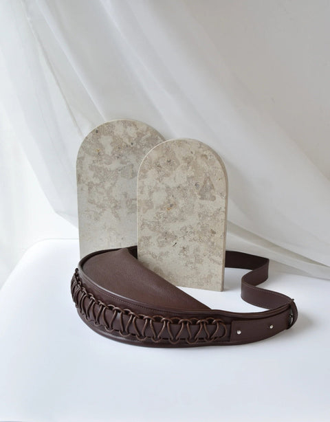 5. Studio shot of Gerda Retter Design Leather Bag Ateena in dark brown, with decorative background