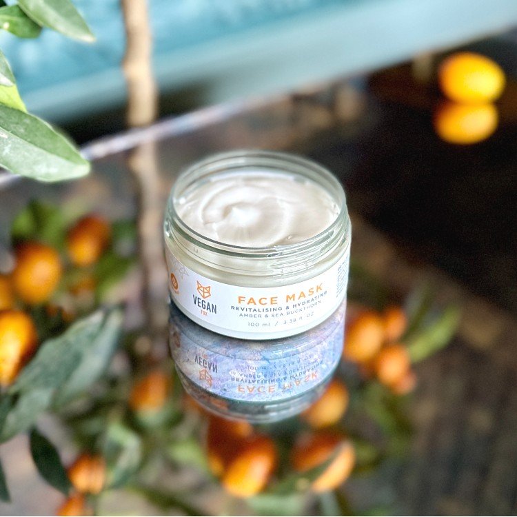 1. Vegan Fox Revitalising & Hydrating Face Mask held in hand, showcasing 100 ml jar in a bath setting