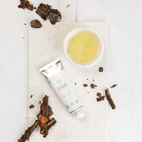 3. Flat lay of Vegan Fox Refreshing Foot Gel with natural ingredients on a marble board