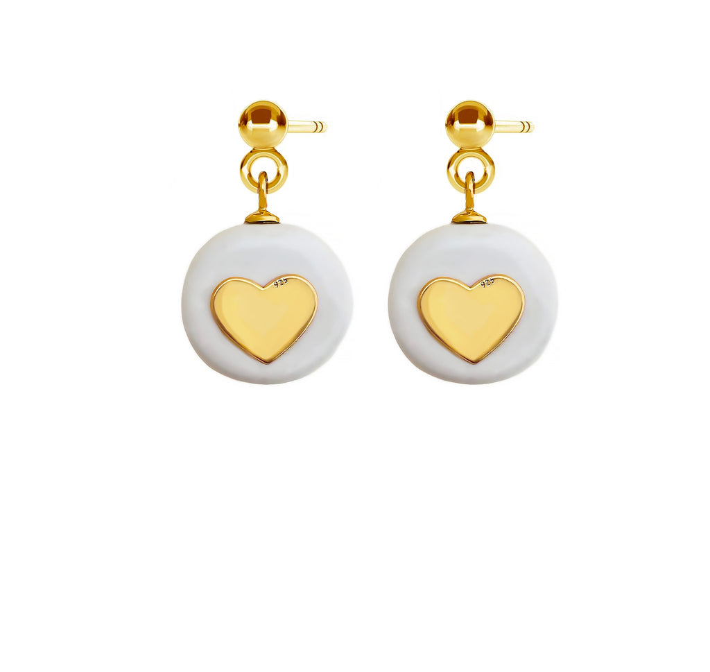 2. SCULP Pure Love Earrings featuring white ceramic pendants and 24K gold-over sterling silver hearts, studio shot