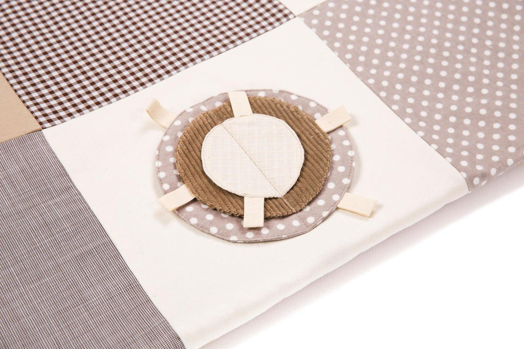 4. Flat lay of Karloova brown activity mat showing patchwork design and interactive elements