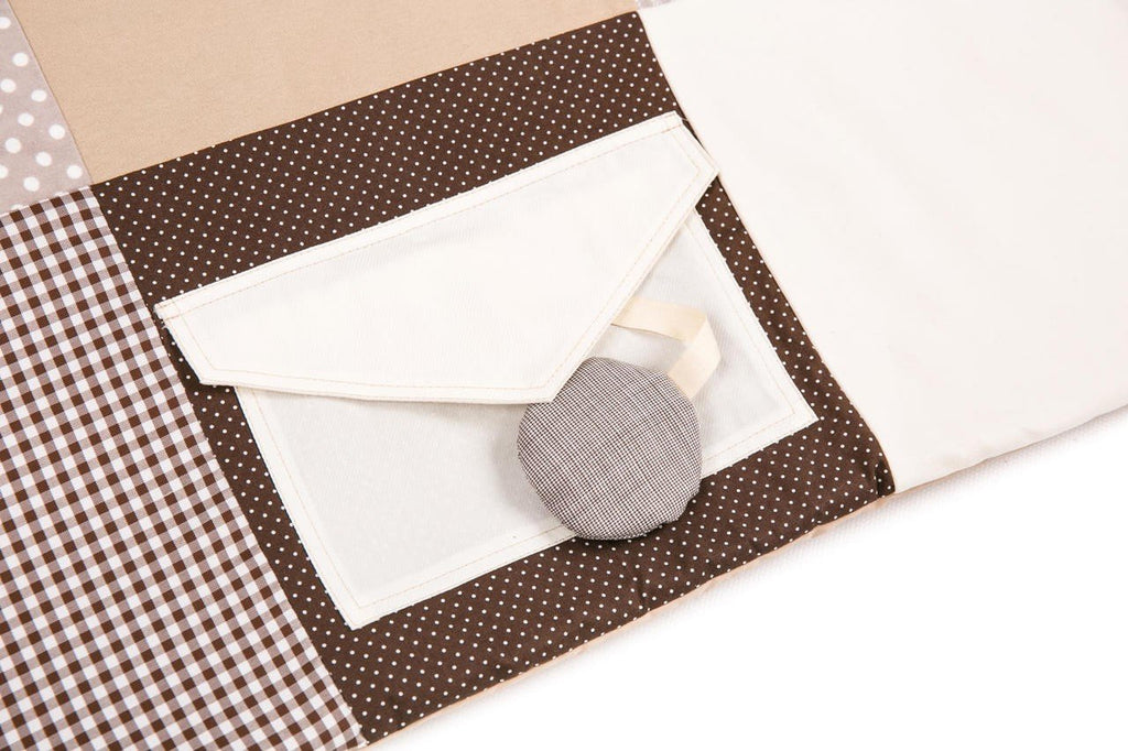 3. Close-up of pocket with squeaky toy on Karloova brown activity mat