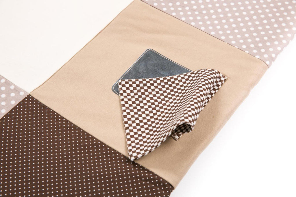 3. Close-up of circular mirror detail on Karloova brown activity mat with polka dot fabric