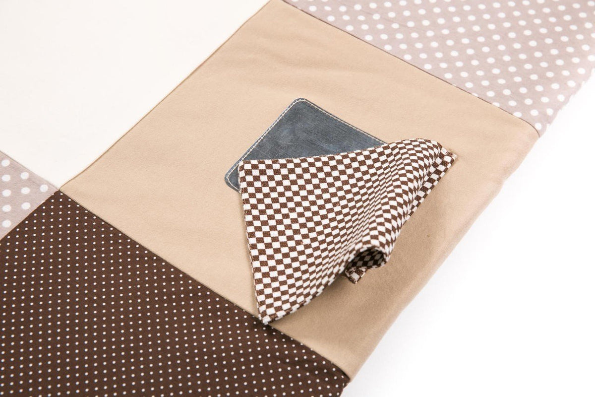 3. Close-up of circular mirror detail on Karloova brown activity mat with polka dot fabric