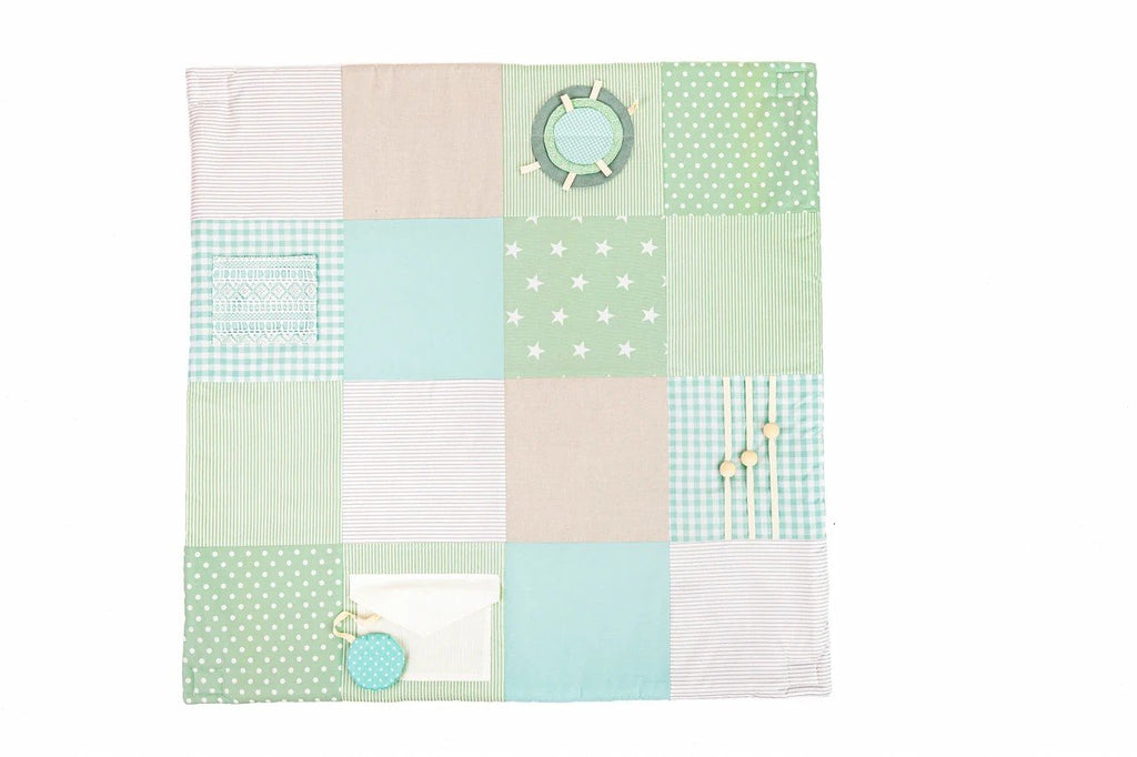 5. Flat lay of mint green baby activity mat showing various textures and interactive elements