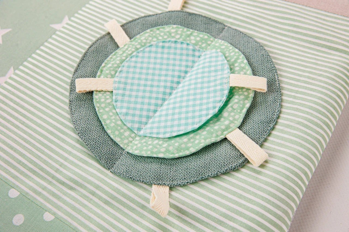 3. Detail of mint green circular fabric element on baby activity mat