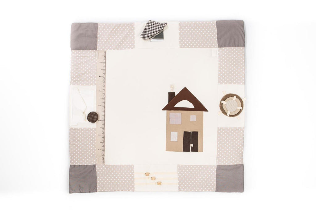 5. Flat lay of brown baby activity mat with house design and measurement scale