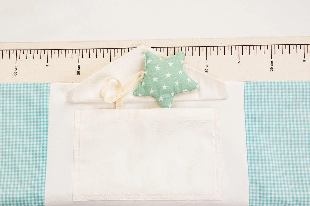 3. Close-up of star-shaped toy and pocket detail on baby activity mat