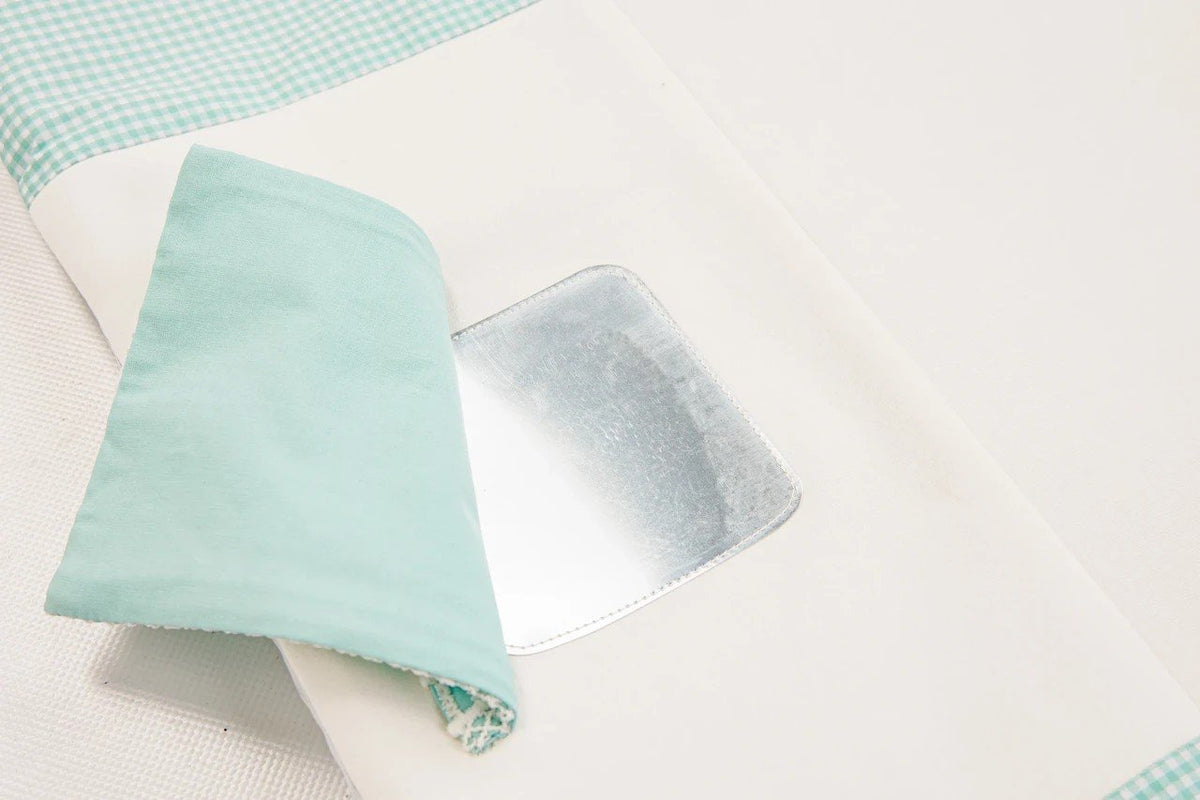 3. Close-up of mint green flap revealing mirror on baby activity mat
