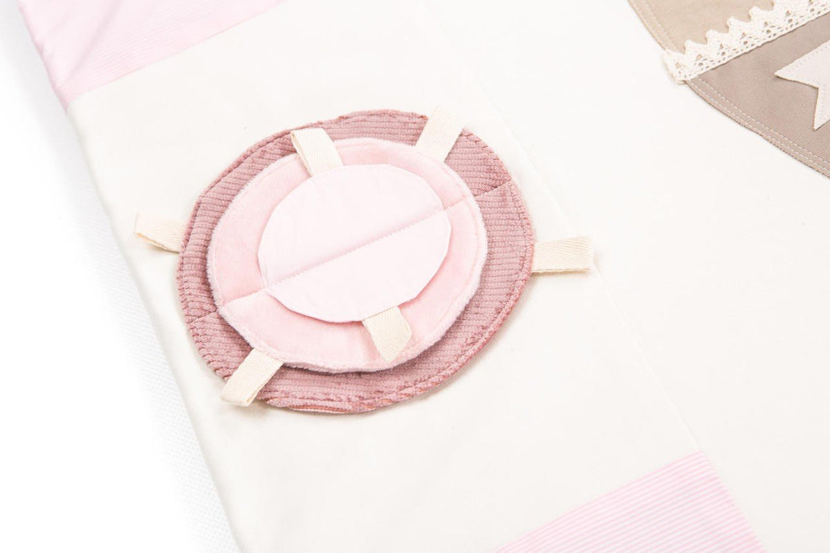 3. Close-up of circular pink textured detail on baby activity mat