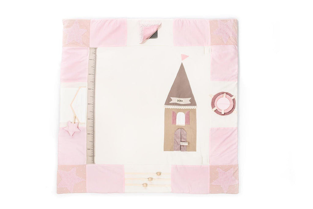 4. Flat lay of pink baby activity mat with decorative house and ruler design