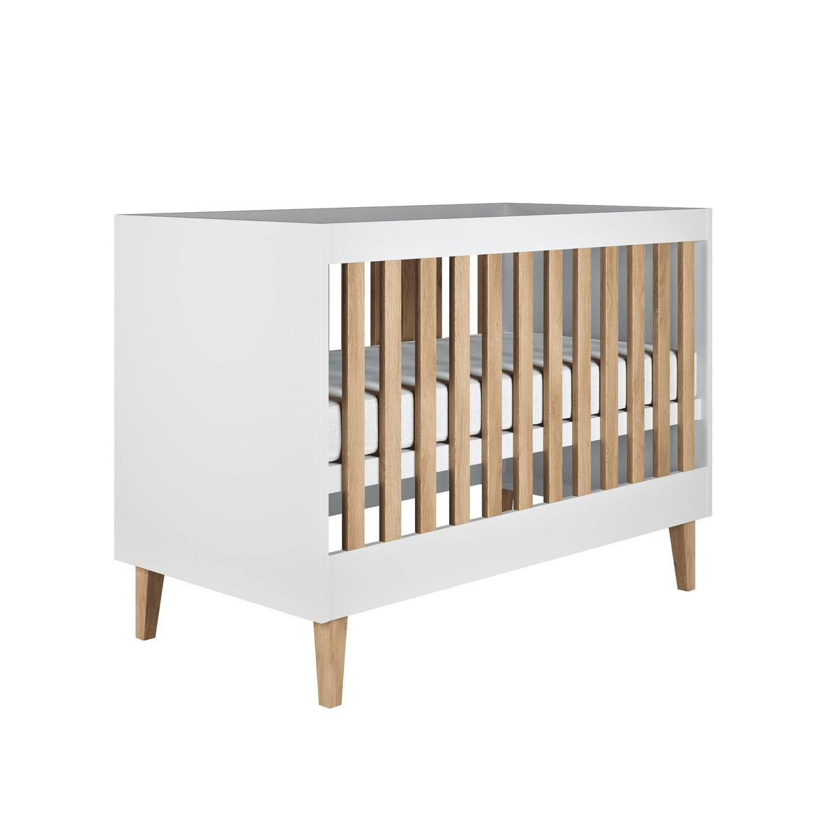 2. White Scandinavian-style baby cot with oak legs and slats, shown in a studio setting