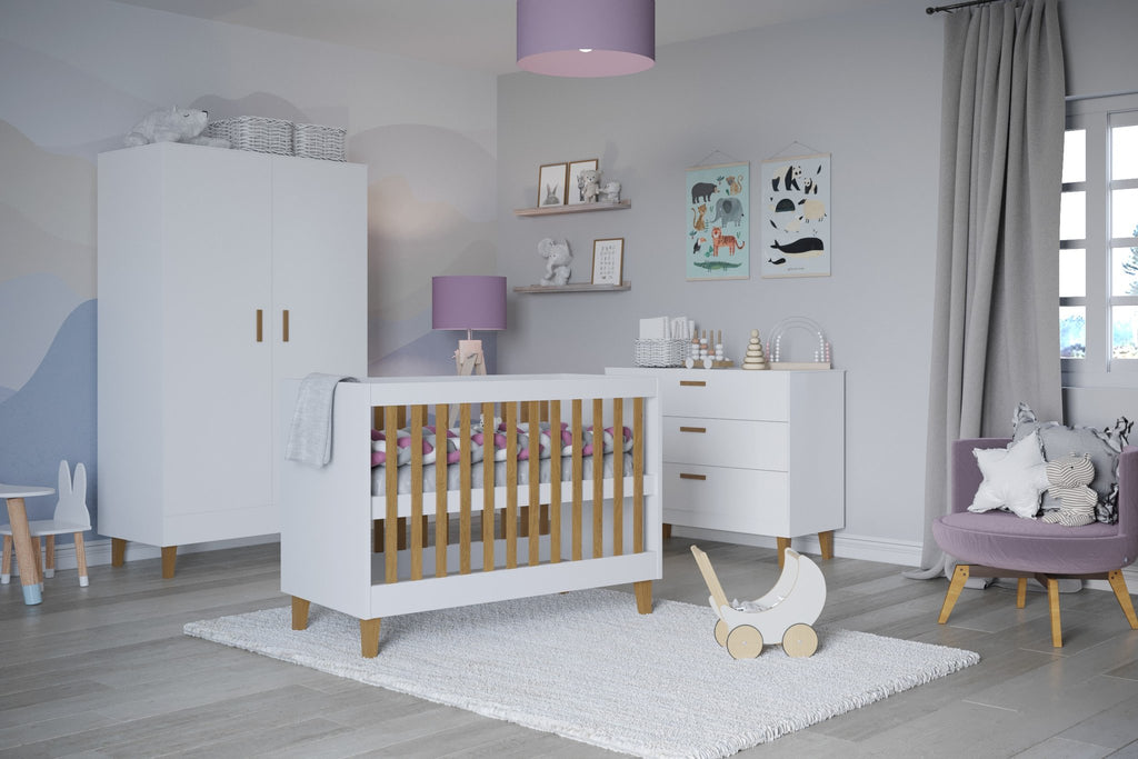 1. White baby cot with oak slats in a stylish nursery with matching furniture and decor