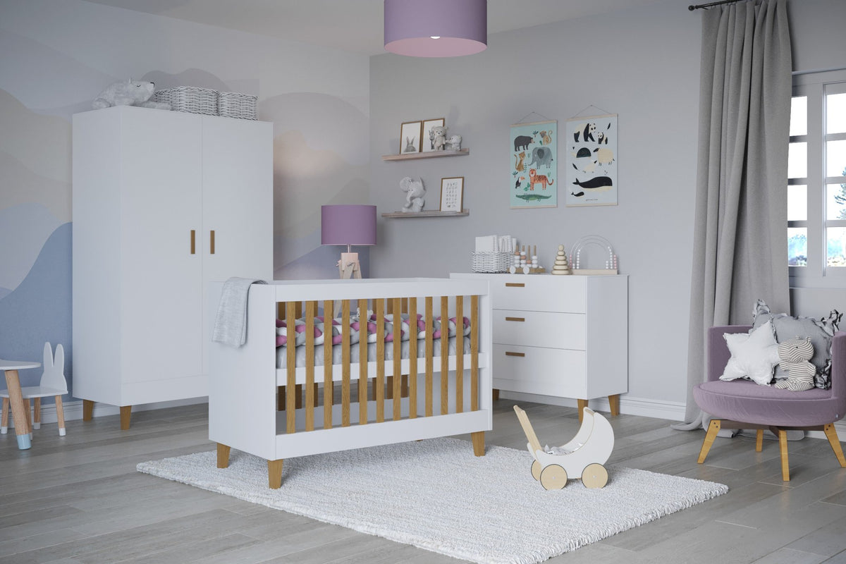 1. White baby cot with oak slats in a stylish nursery with matching furniture and decor