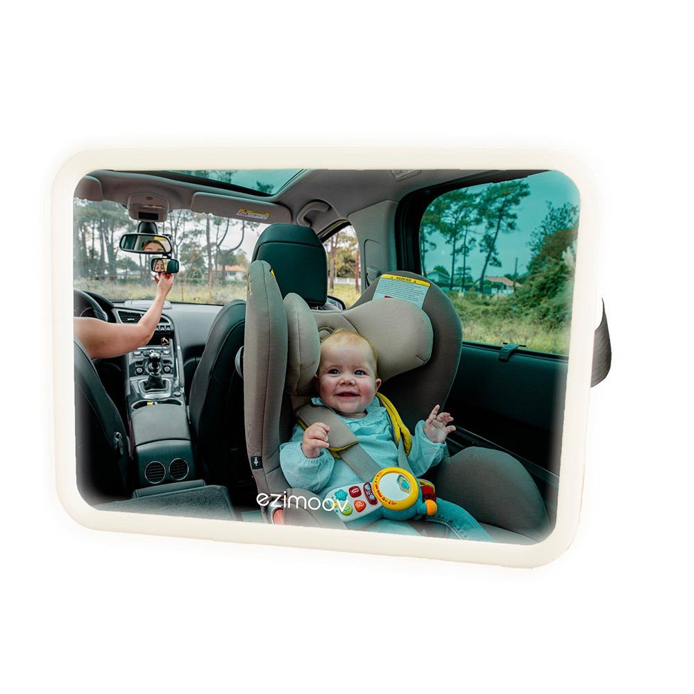 1. Baby in car seat visible through Ezimoov LED car mirror with driver adjusting rearview, outdoor setting