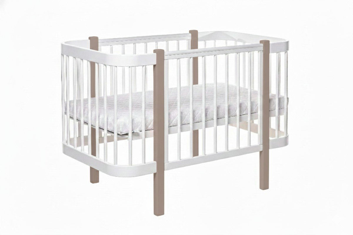 2. Studio view of KOTTO ELIN crib in cappuccino and white, featuring slatted sides and mattress