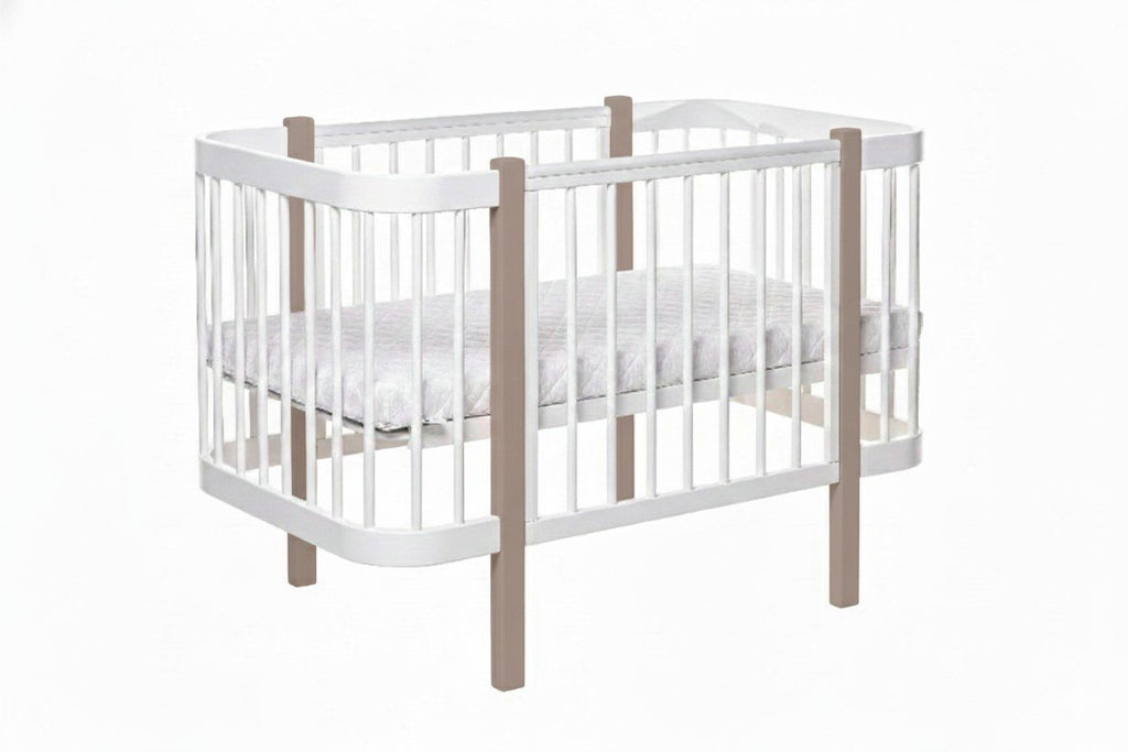 2. Studio view of KOTTO ELIN crib in cappuccino and white, featuring slatted sides and mattress