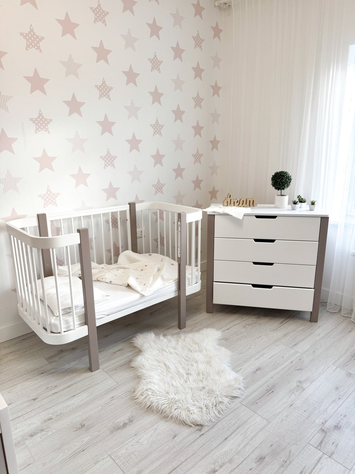1. KOTTO ELIN crib in cappuccino and white in nursery with star wallpaper, paired with white dresser