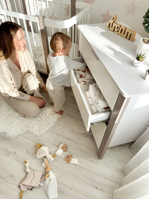 1. Woman and baby near KOTTO ELIN crib in cappuccino and white, nursery setting with toys on floor